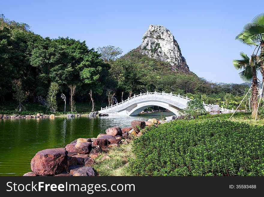 Chinese garden landscape:stone arch bridge and hill. Chinese garden landscape:stone arch bridge and hill