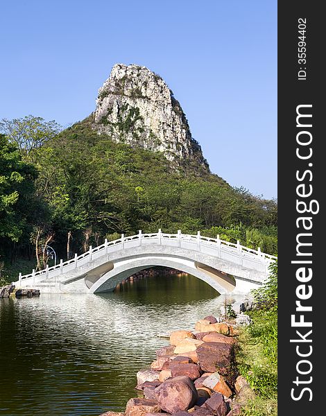 Chinese garden landscape:stone arch bridge and hill. Chinese garden landscape:stone arch bridge and hill