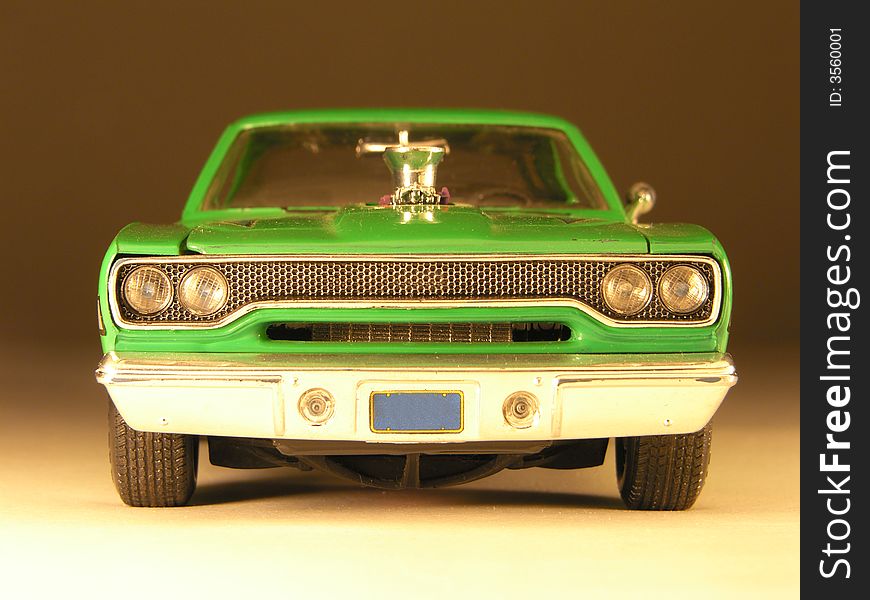 Plastic model of a green muscle car very well detailed in front view. Plastic model of a green muscle car very well detailed in front view