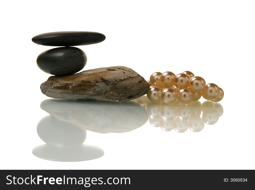 Pebble stone and pearl necklace over white background. Pebble stone and pearl necklace over white background