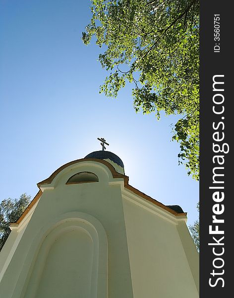 Church in the wood, cross and clear blue sky