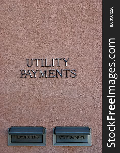 Utility Payments sing on stucco wall