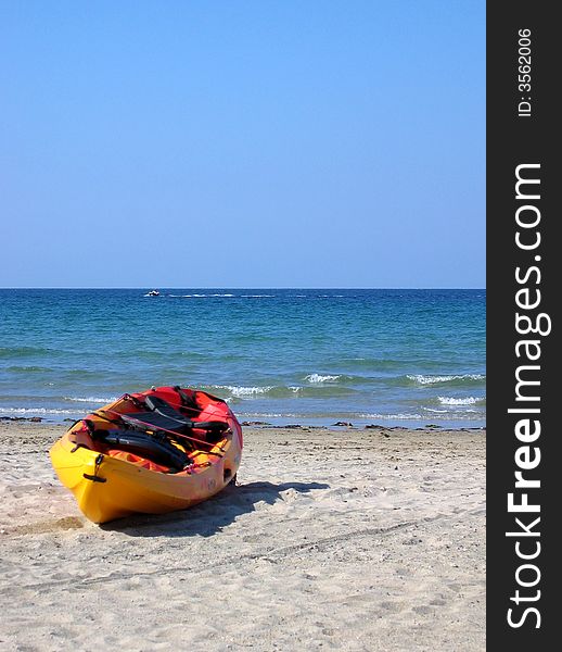 Yellow and red kayak on the beach