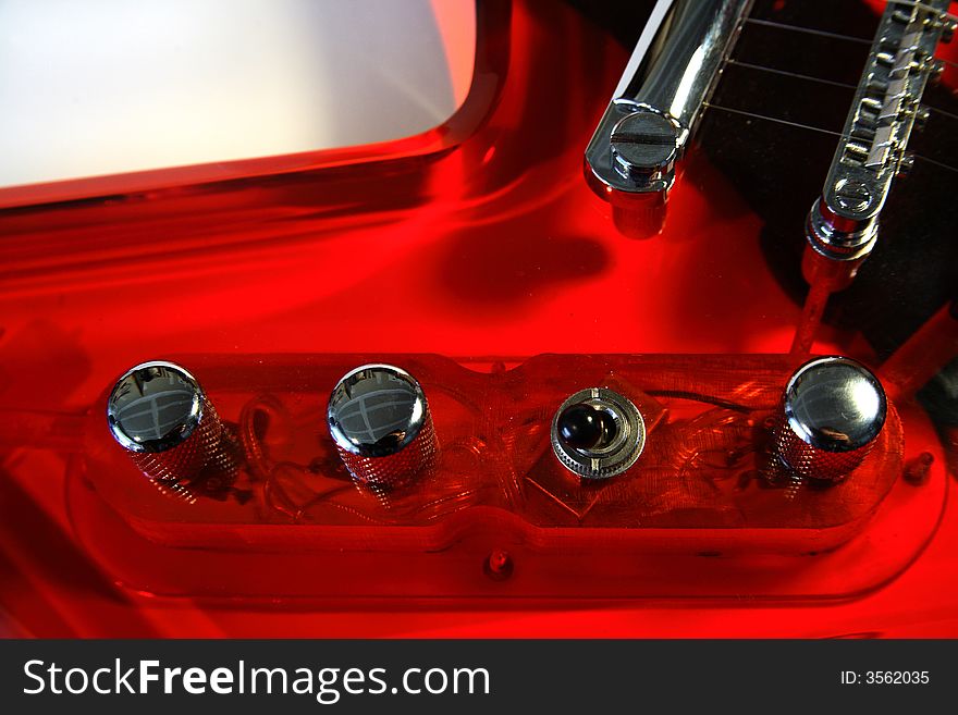 Guitar knobs on a red acrylic guitar