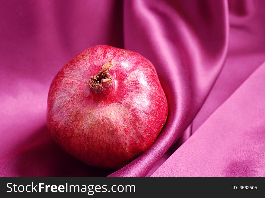 Piece of pomegranate on pink background