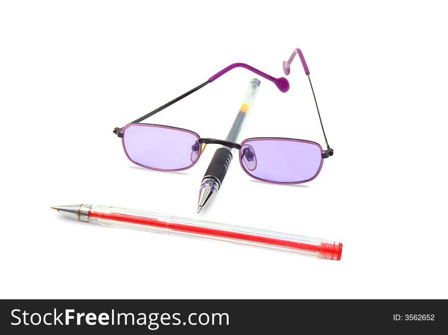 Isolated red and black pens and lilac glasses. Isolated red and black pens and lilac glasses
