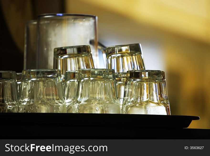 Clean glass on tray waiting in a cafe or bar. Clean glass on tray waiting in a cafe or bar