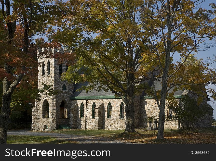 Stone Church with lined and framed trees around