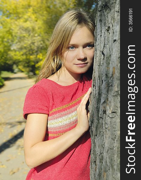 Attractive blond girl in the autumn park