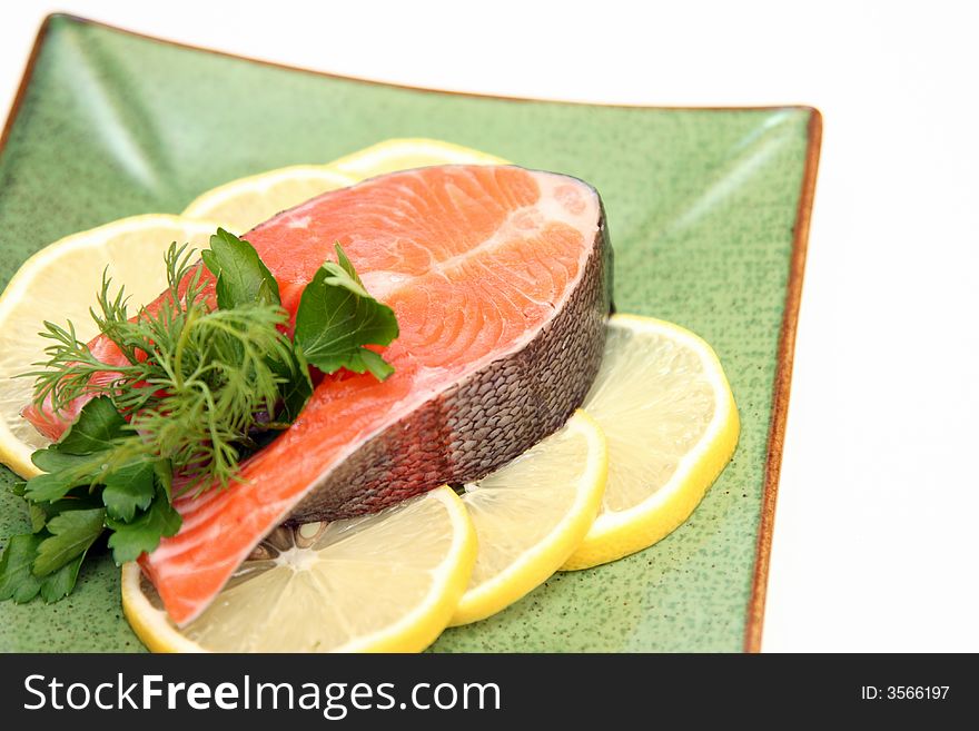 Salmon with lemon and parsley on plate