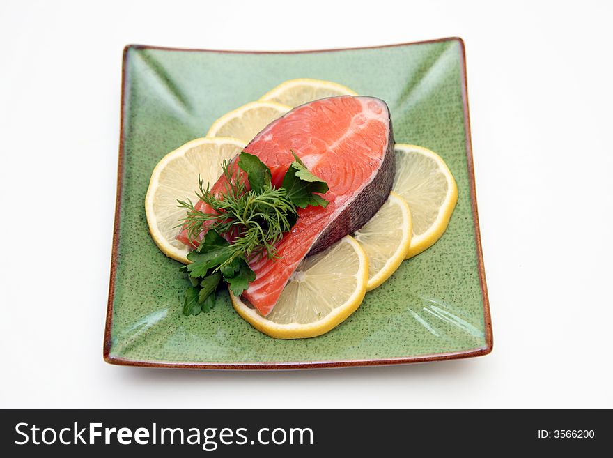 Salmon with lemon and parsley on plate