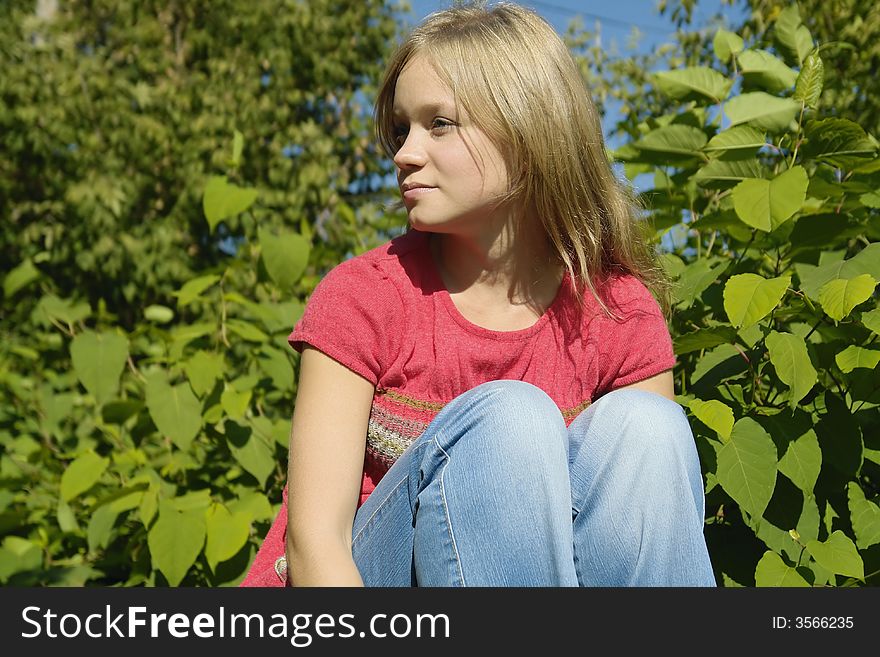 Blond thoughtful girl in the park