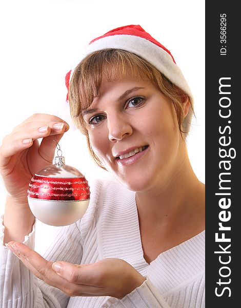 A young beautiful cute and happy Christmas woman is smiling. Isolated over white with a Christmas glitter ball. A young beautiful cute and happy Christmas woman is smiling. Isolated over white with a Christmas glitter ball.