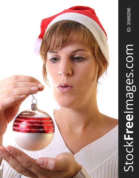 A young beautiful cute and happy Christmas woman is smiling. Isolated over white with a Christmas glitter ball. A young beautiful cute and happy Christmas woman is smiling. Isolated over white with a Christmas glitter ball.