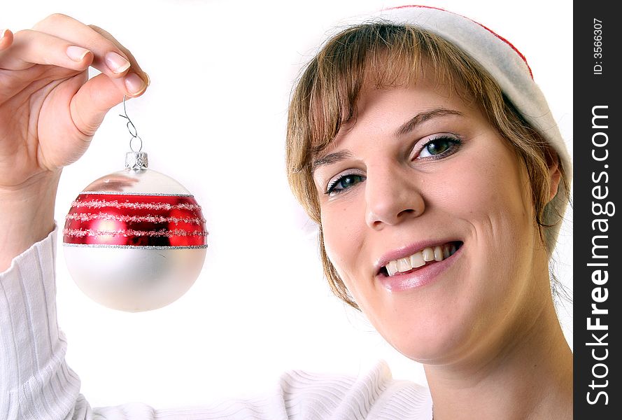 A young beautiful cute and happy Christmas woman is smiling. Isolated over white with a Christmas glitter ball. A young beautiful cute and happy Christmas woman is smiling. Isolated over white with a Christmas glitter ball.