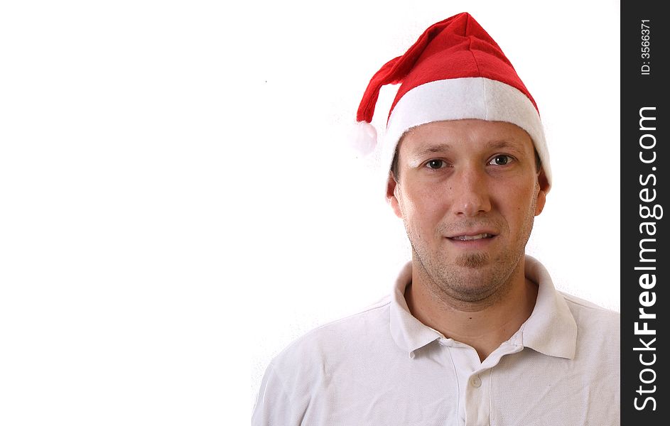 A young man with a santa claus hat is smiling. Isolated over white! Lots of copyspace to write text in!. A young man with a santa claus hat is smiling. Isolated over white! Lots of copyspace to write text in!
