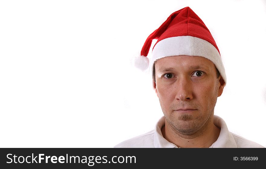 A young man with a santa claus hat. Isolated over white! Lots of copyspace to write text in!. A young man with a santa claus hat. Isolated over white! Lots of copyspace to write text in!