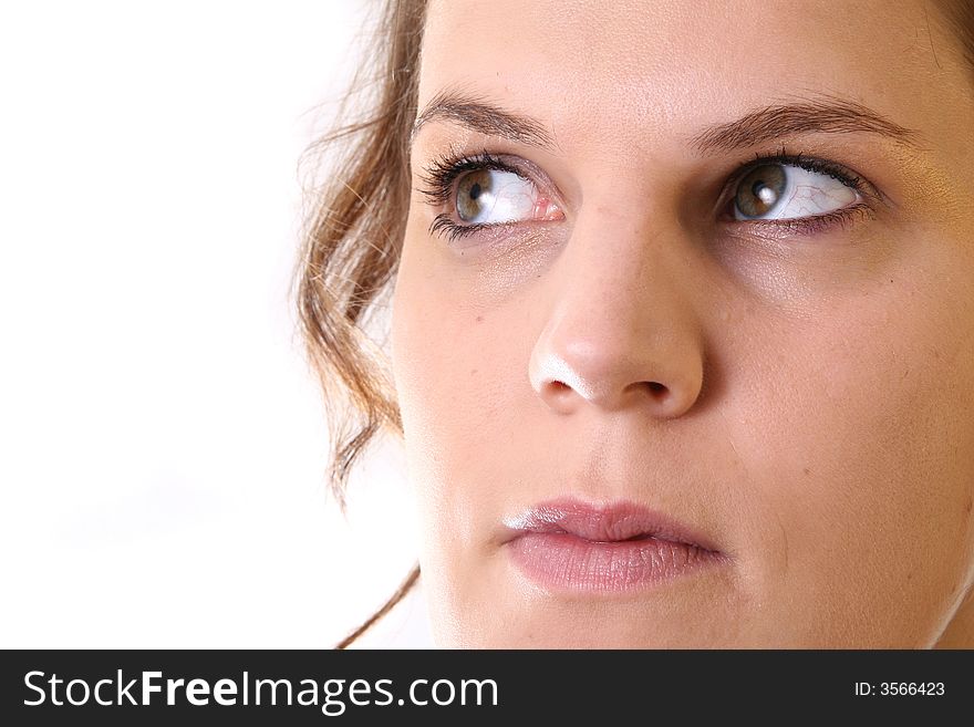 A young woman is looking up into the corner over white background. Ideal for business and corporate purposes. Lots of white copyspace and room for text on this isolated area. A young woman is looking up into the corner over white background. Ideal for business and corporate purposes. Lots of white copyspace and room for text on this isolated area.