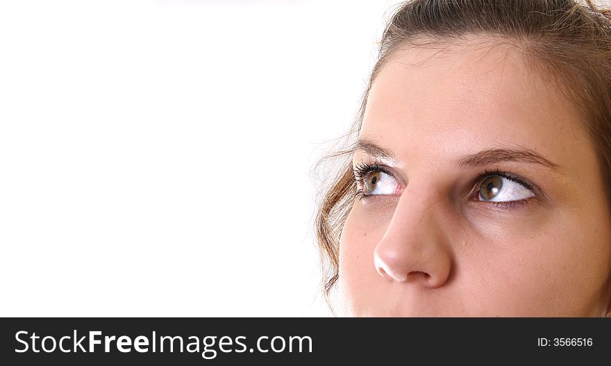 A young woman is looking up into the corner over white background. Ideal for business and corporate purposes. Lots of white copyspace and room for text on this isolated area.