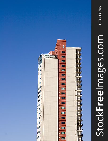 A high rise condo tower against blue sky. A high rise condo tower against blue sky