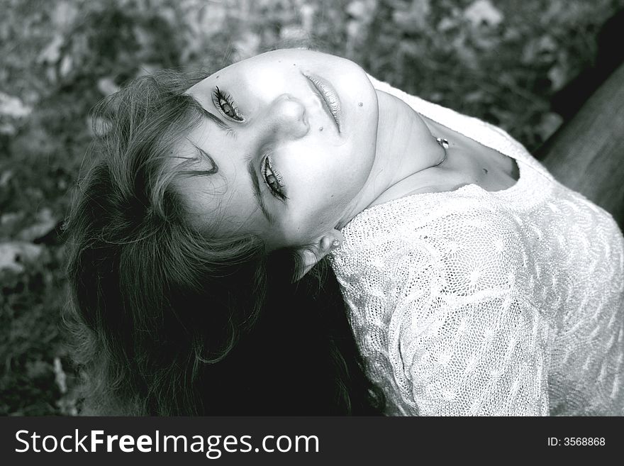 Charming young girl sitting in the park. Charming young girl sitting in the park