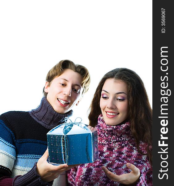 A man and a woman exchanging Christmas gifts