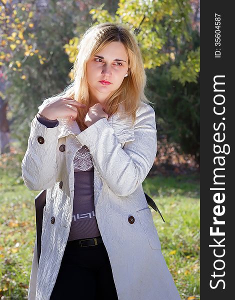 Portrait of a young woman in autumn park
