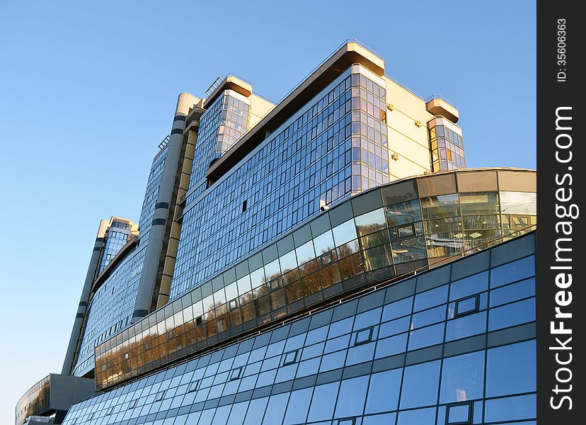 The modern city building against the blue sky.