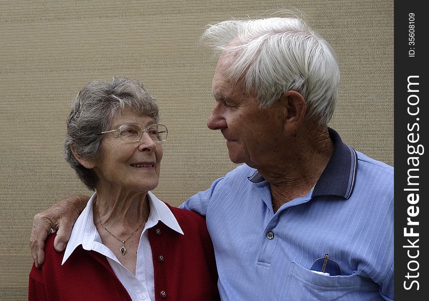 A devoted elderly couple share a quiet moment and a loving bond.