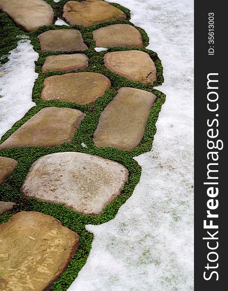Stone footpath in snow