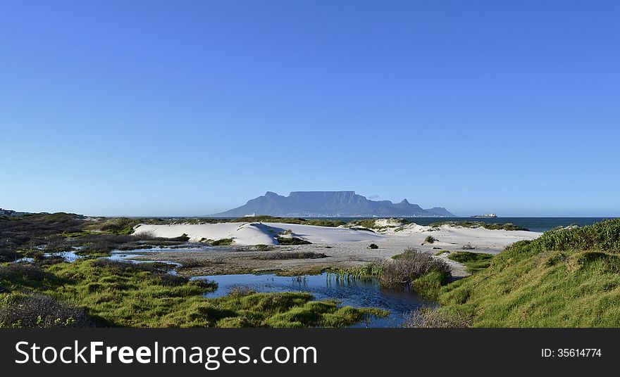 Landscape with sand dunes and Table Mountain