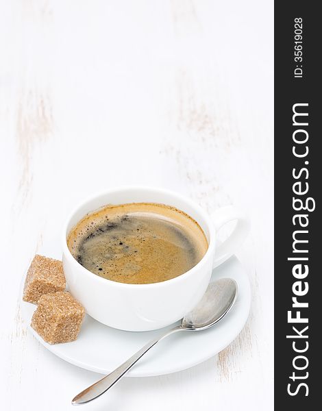 Cup of coffee with sugar on white table and space for text