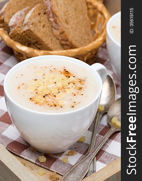 Delicious cream soup of cauliflower with cheese and pepper, close-up, vertical. Delicious cream soup of cauliflower with cheese and pepper, close-up, vertical