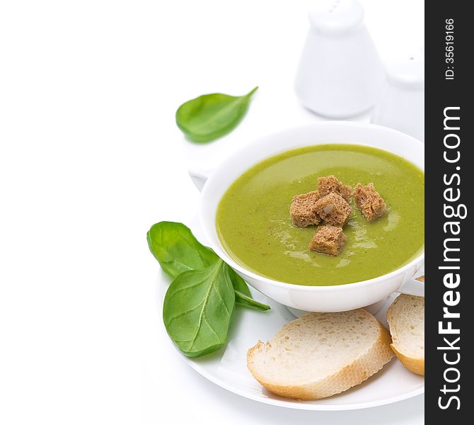 Delicious spinach soup with croutons, close-up, isolated on white