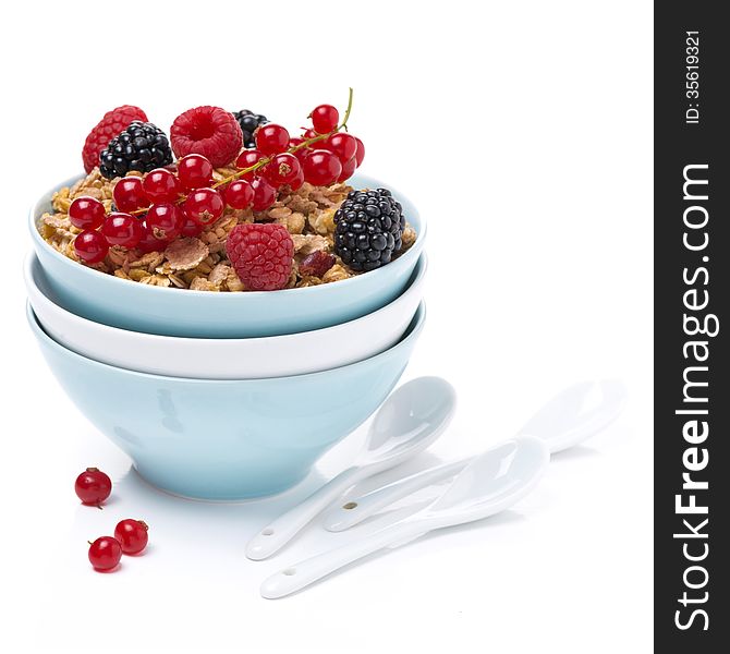 Homemade granola with berries in bowls and spoons,  isolated