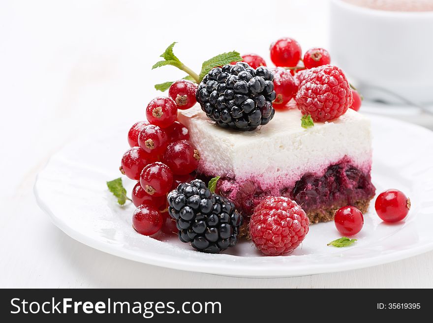 Piece of cheesecake with fresh berries and coffee, close-up