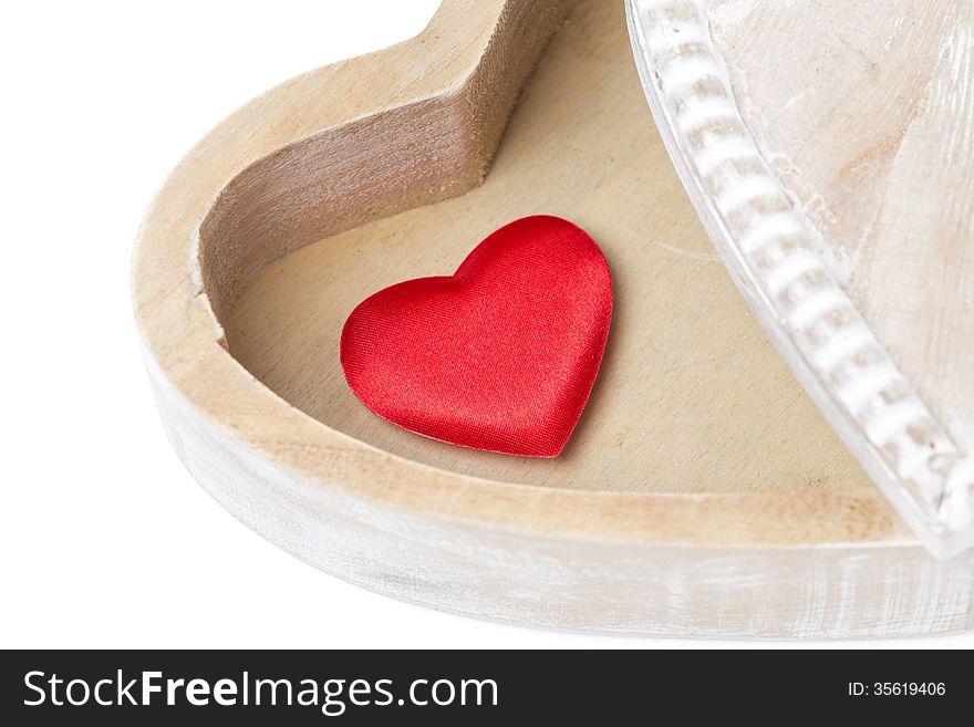 Red heart in a wooden box, isolated on white
