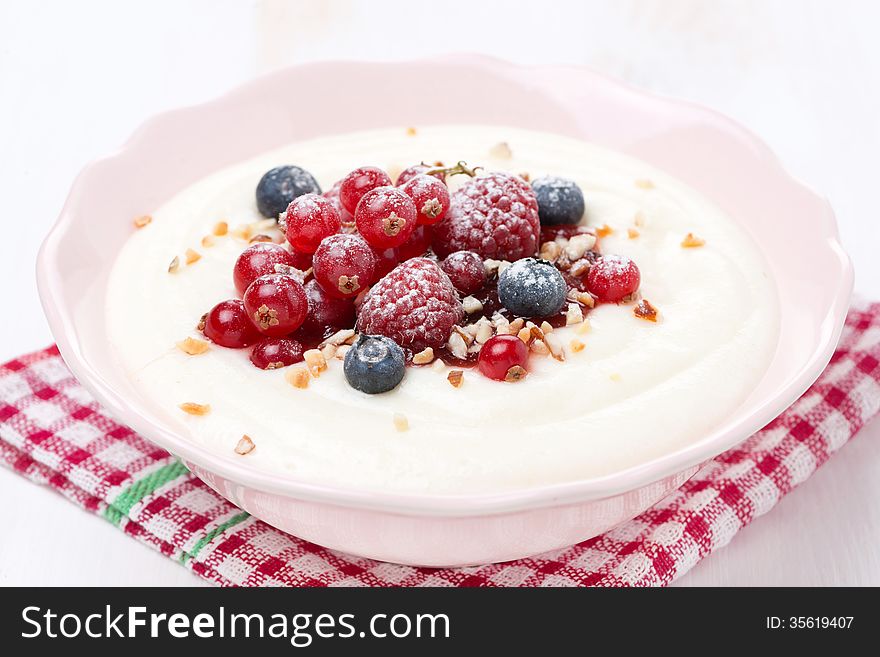 Semolina porridge with berries and nuts, close-up