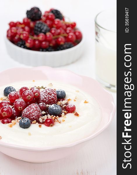 Semolina porridge with fresh berries and nuts, close-up