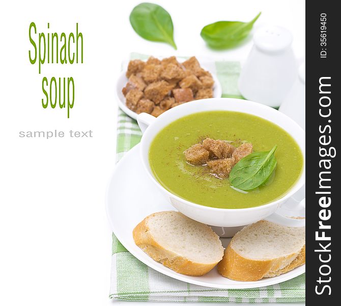 Spinach soup with croutons, isolated on white