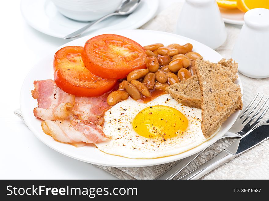 Traditional English breakfast with fried egg, bacon