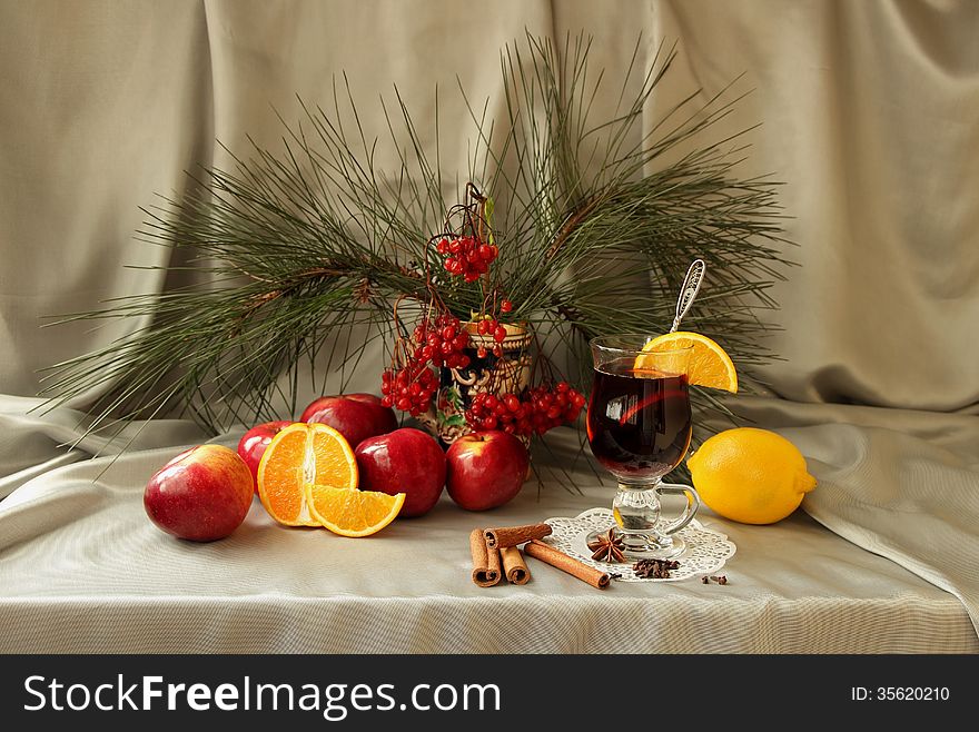 Still life with mulled wine, apple, orange and spices