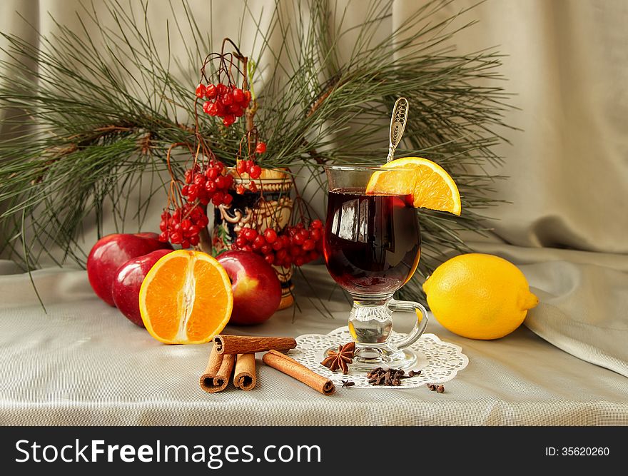 Glass of mulled wine, cooked with spices, honey and orange slices. Glass of mulled wine, cooked with spices, honey and orange slices