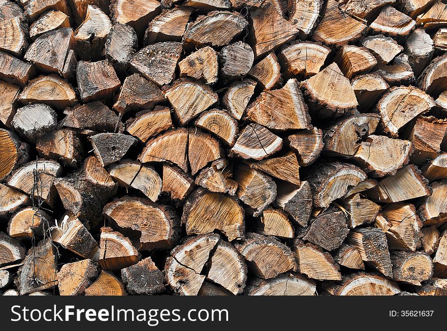 Background of stacked chopped wood prepared for winter