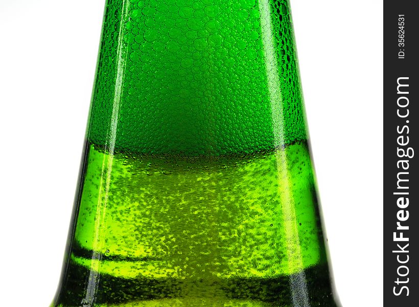 Green bottle of beer and gas bubbles