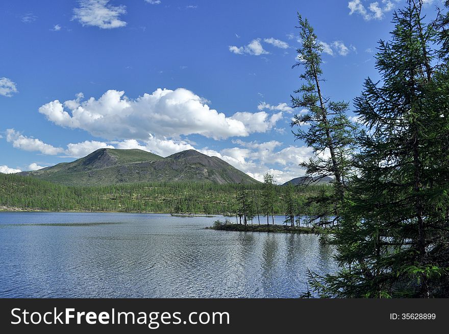 Landscape With A Lake And Mountains Along The Banks.