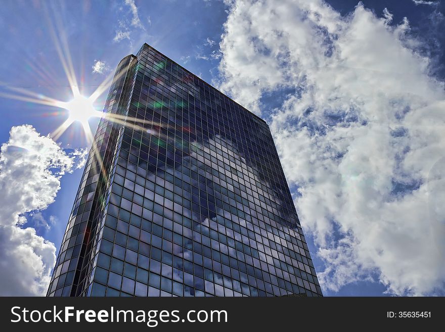 Glass skyscraper on the background of sky and sun. Glass skyscraper on the background of sky and sun