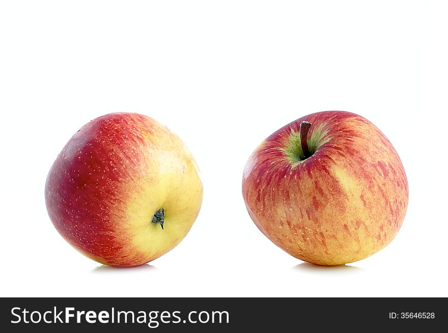 Two fresh sweet apples on a white background