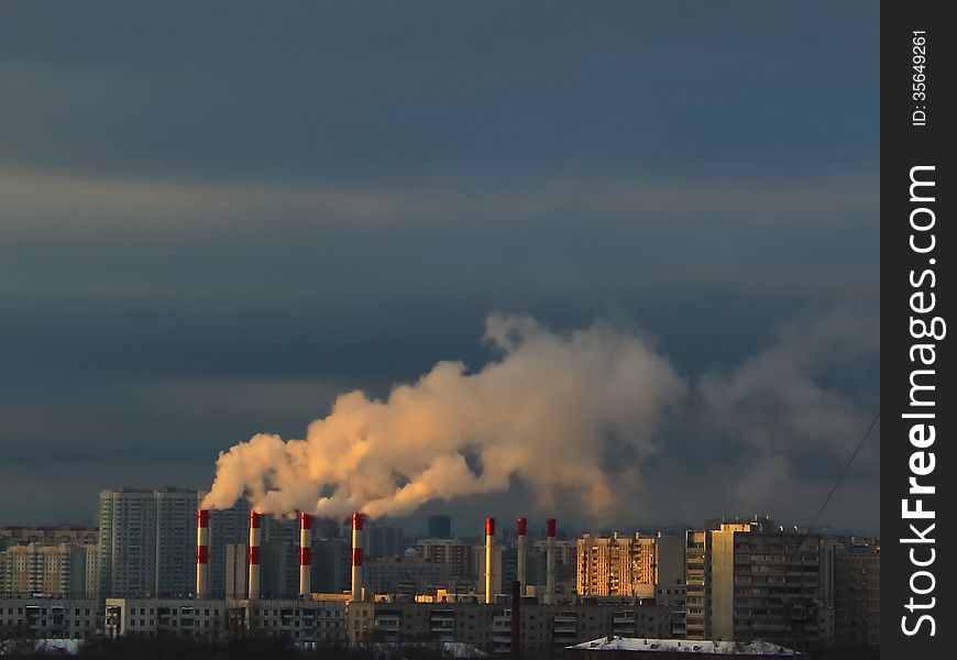 Thermal power plant steam amidst apartments in Moscow, Russia