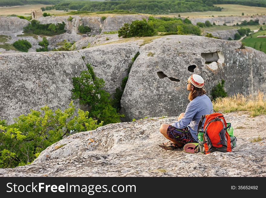 Hiking man having rest at the top of Eski Kermen, Crimea, Ukraine